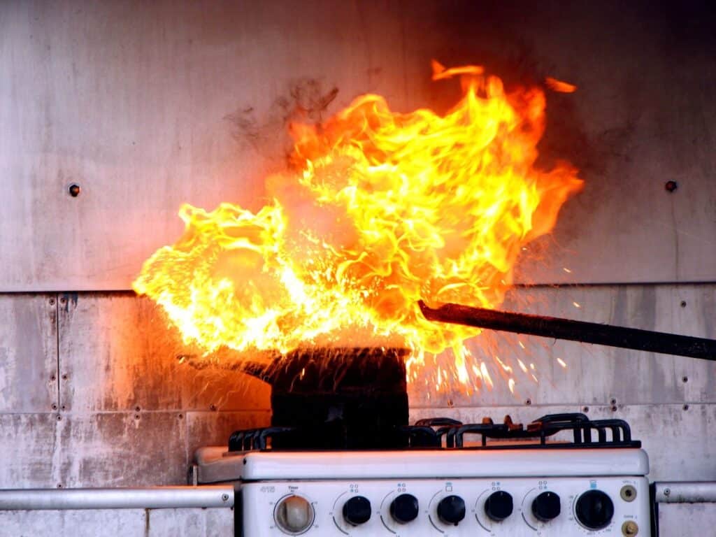 A fire burning on a stove, potential fire damage, fire damage clean up, top causes of house fires